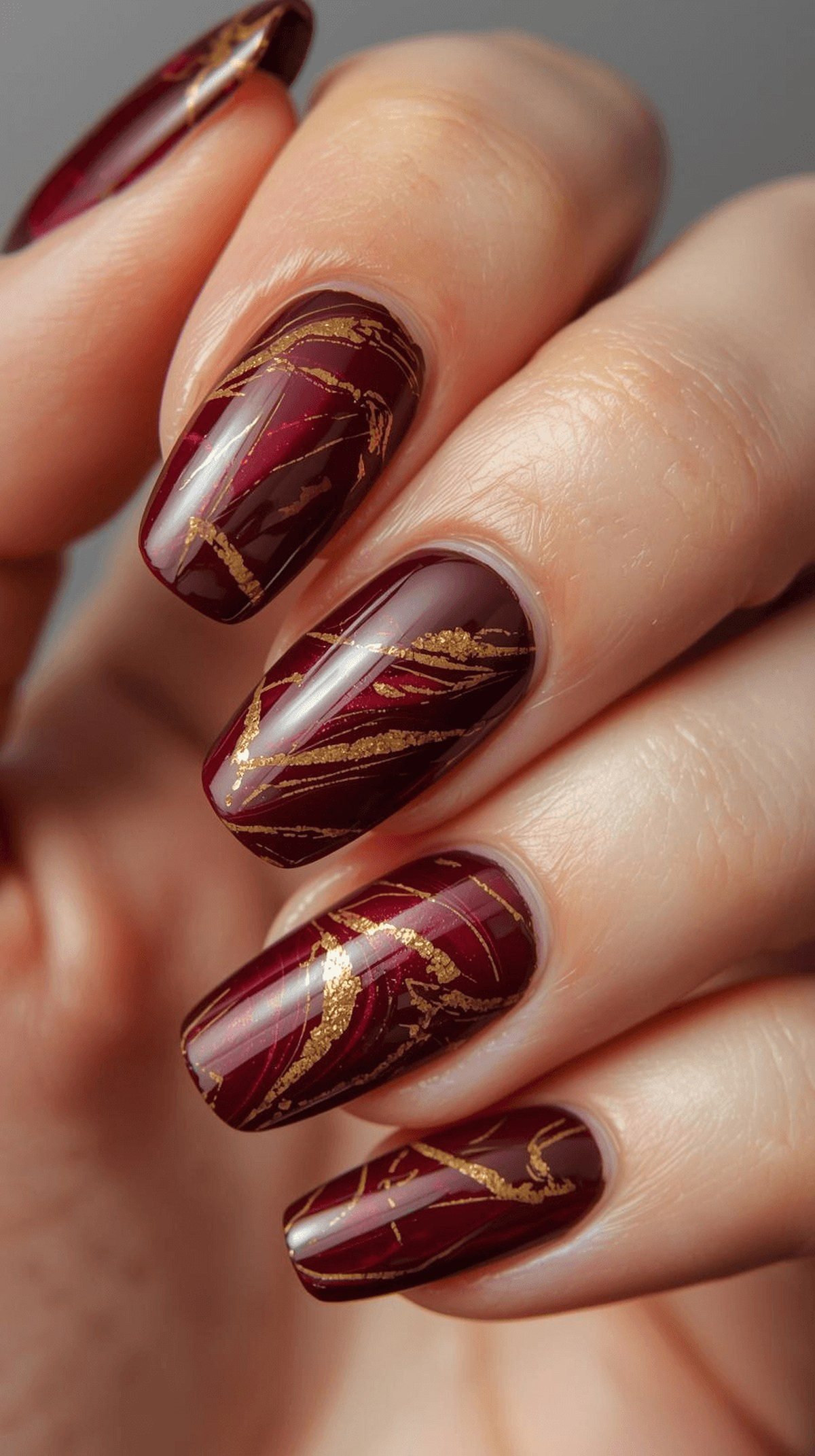Burgundy marble nails with gold veining for hoco