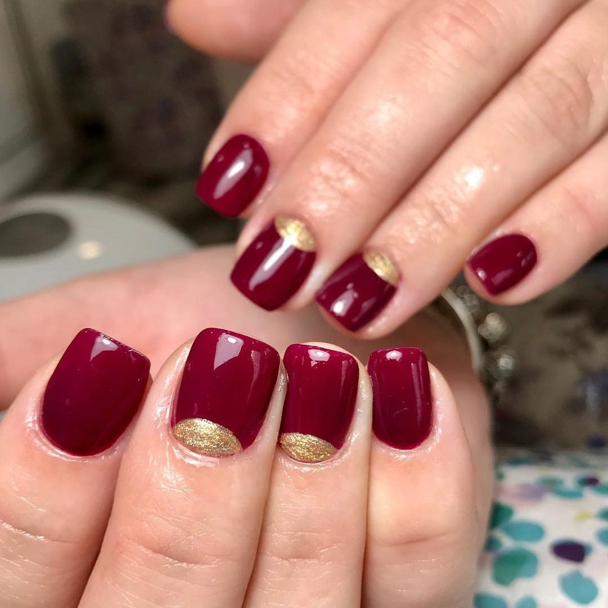 Burgundy half-moon nails with gold cuticle detail for hoco
