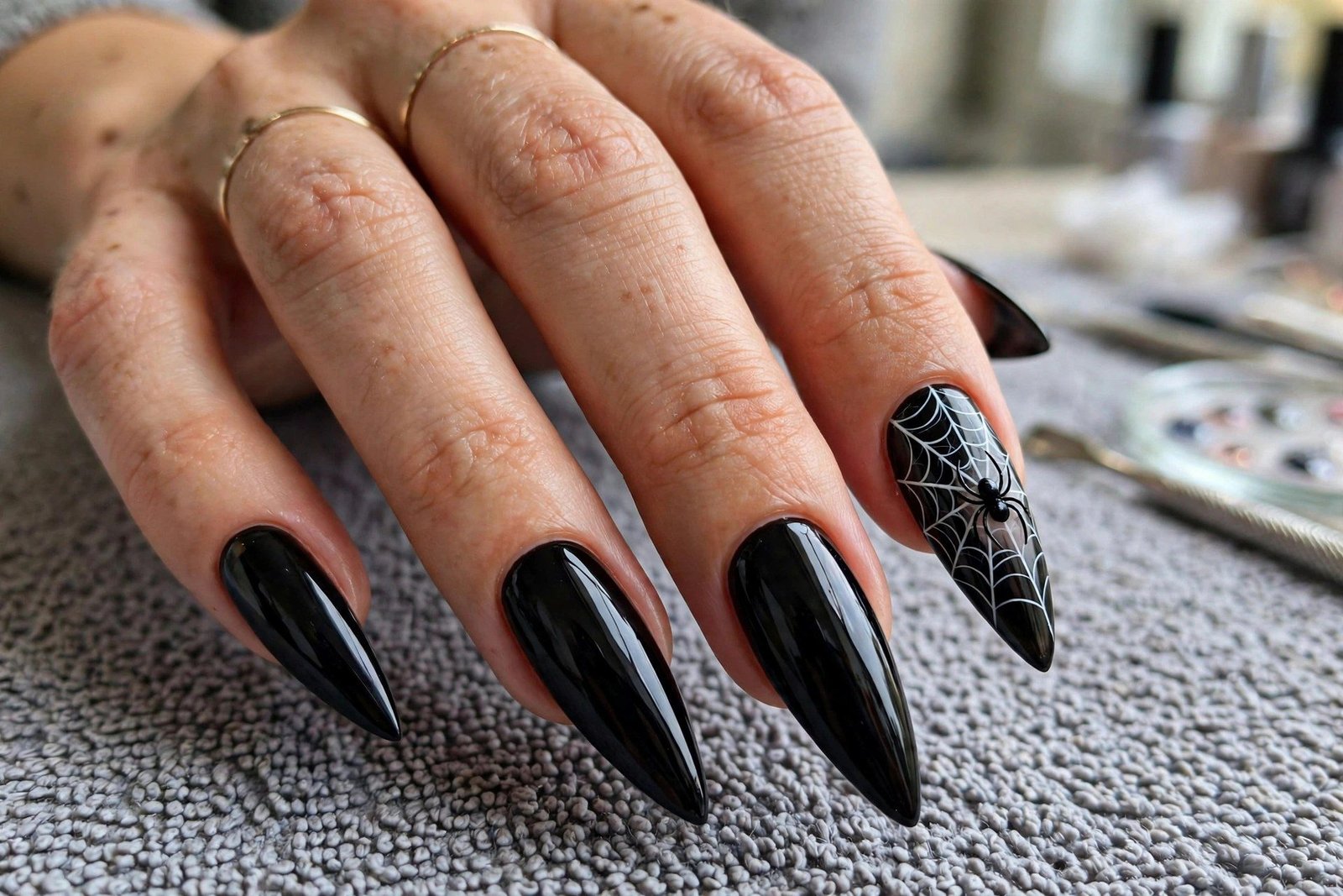 Spider accent nail art on long black nails