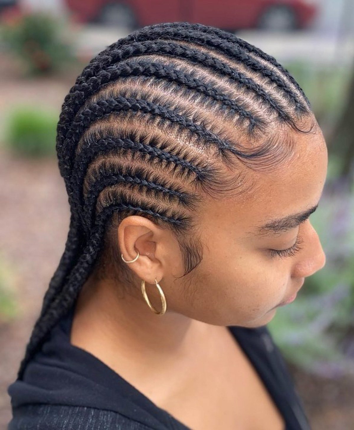 Feed-in braids styled with a deep side part