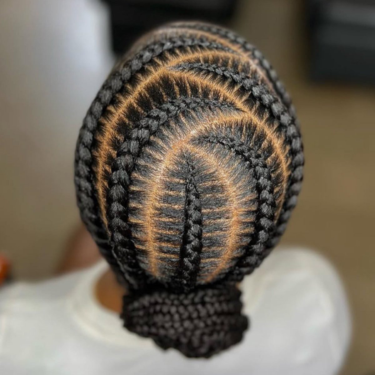 Feed-in braids wrapped into a low bun