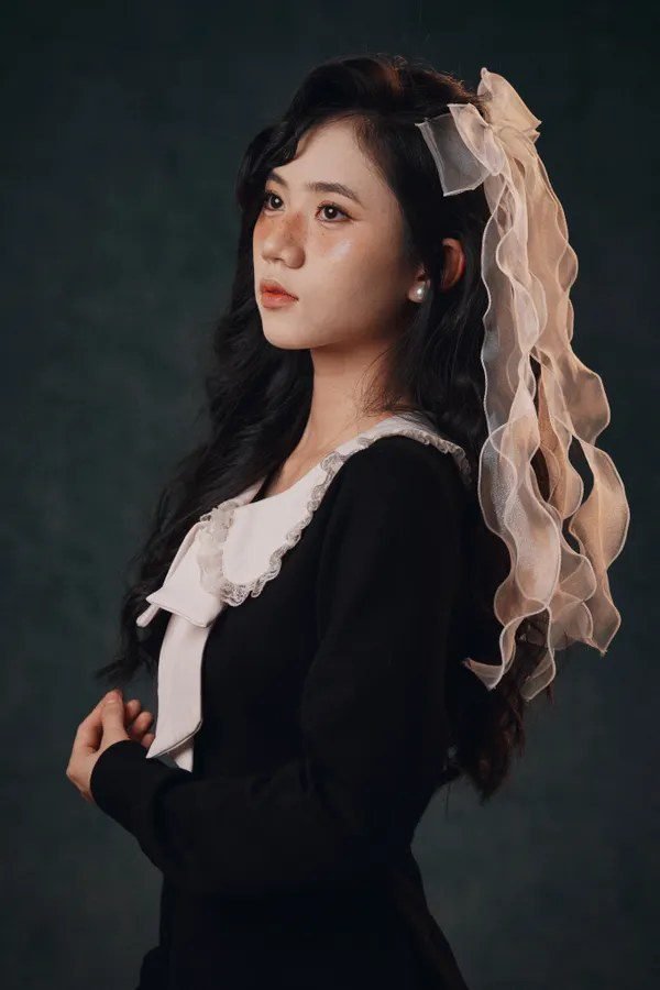 Woman in black dress with white collar, Wednesday Addams style