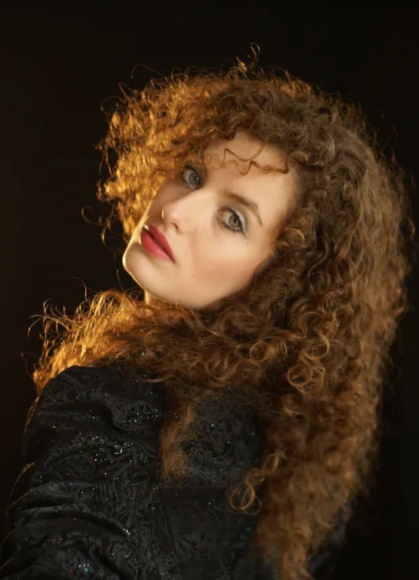 Woman with big curly hair for a witch costume