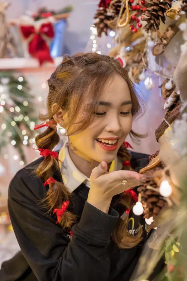 Woman with braided pigtails and ribbons