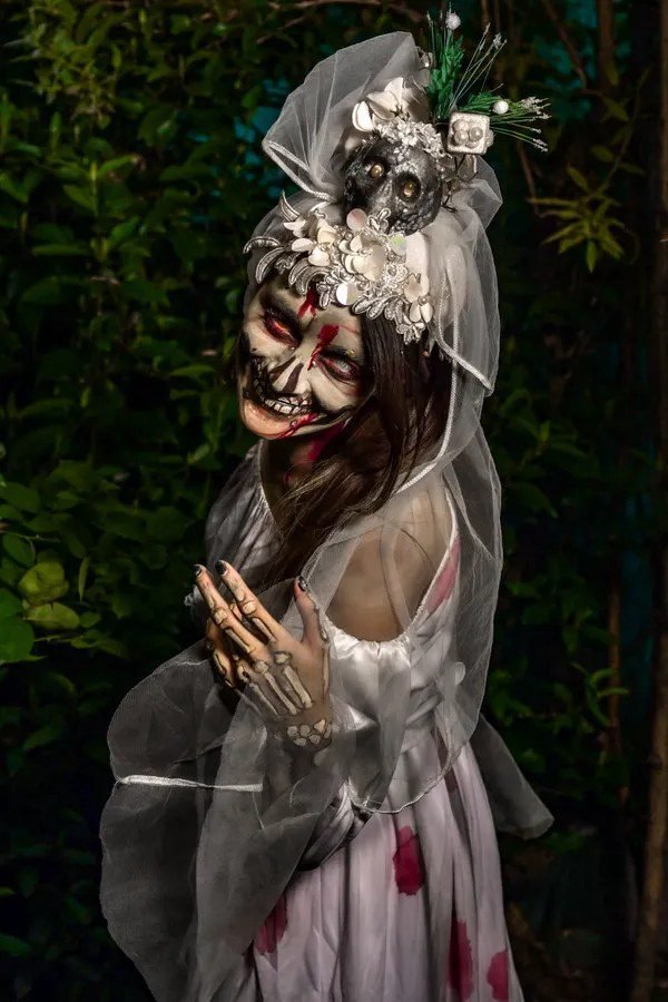 Woman in a ghost bride Halloween costume
