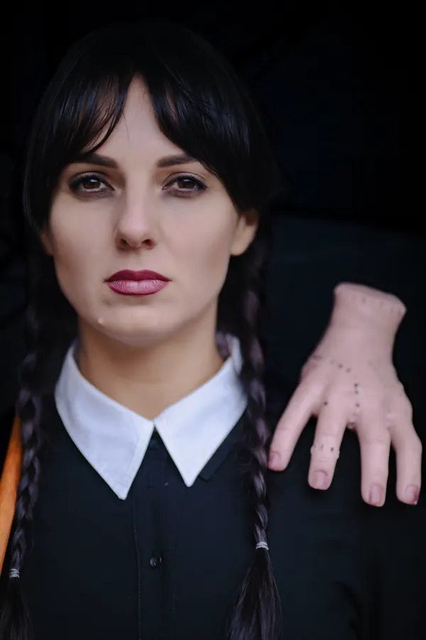 Woman in a Wednesday Addams costume