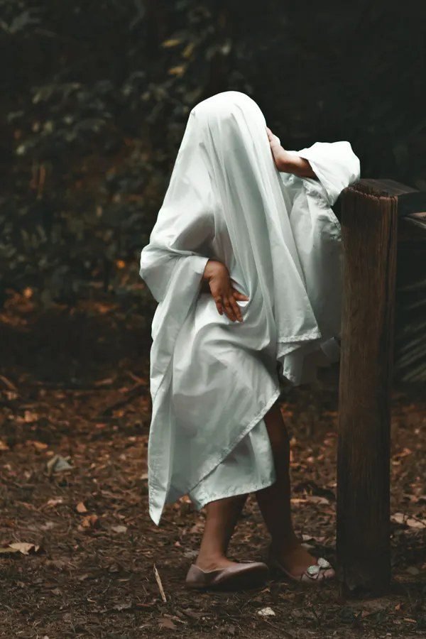 Woman in white sheet ghost style