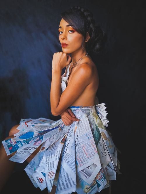 Woman in a newspaper print dress costume