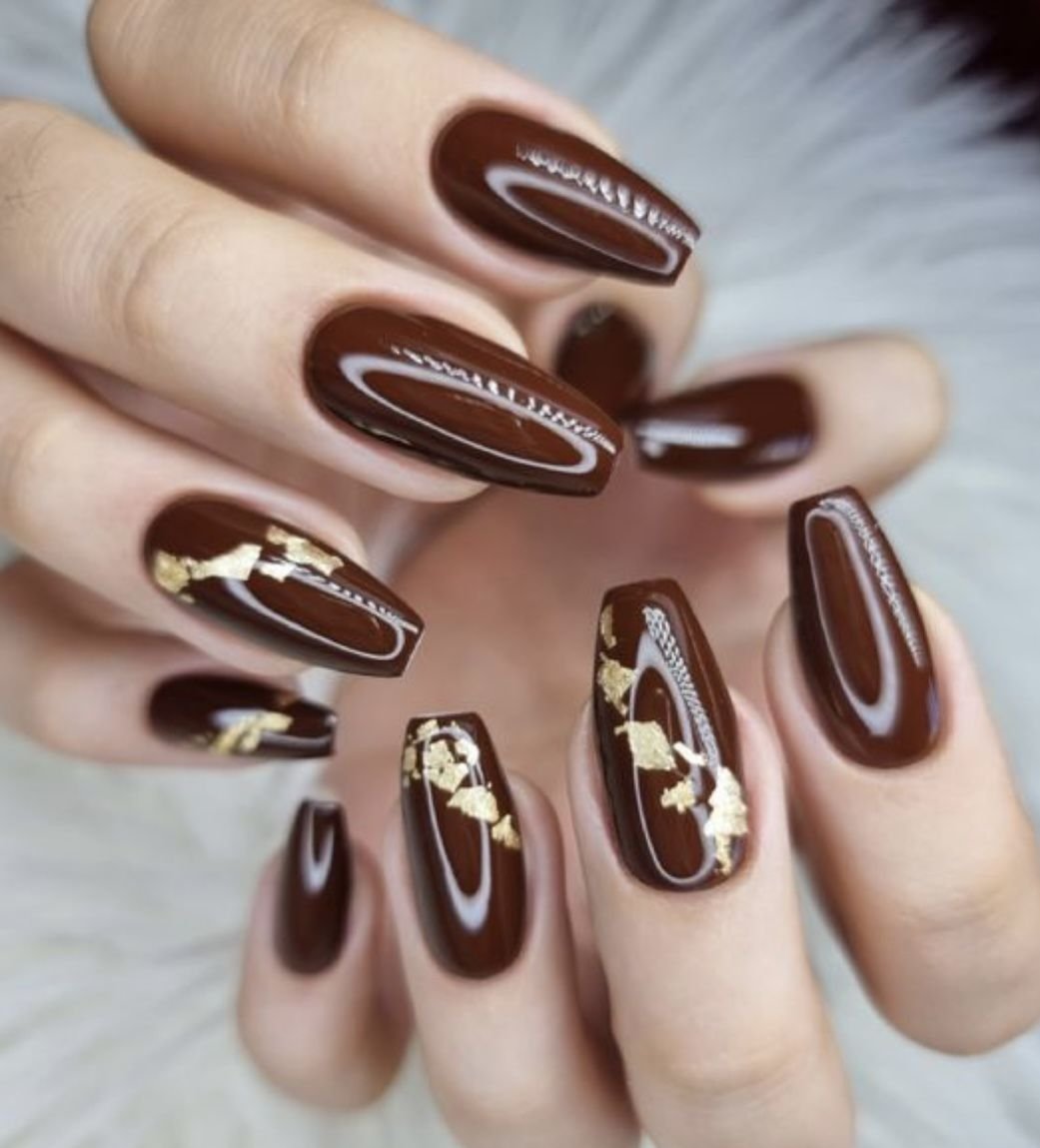 Chocolate brown nails with gold foil flake accents