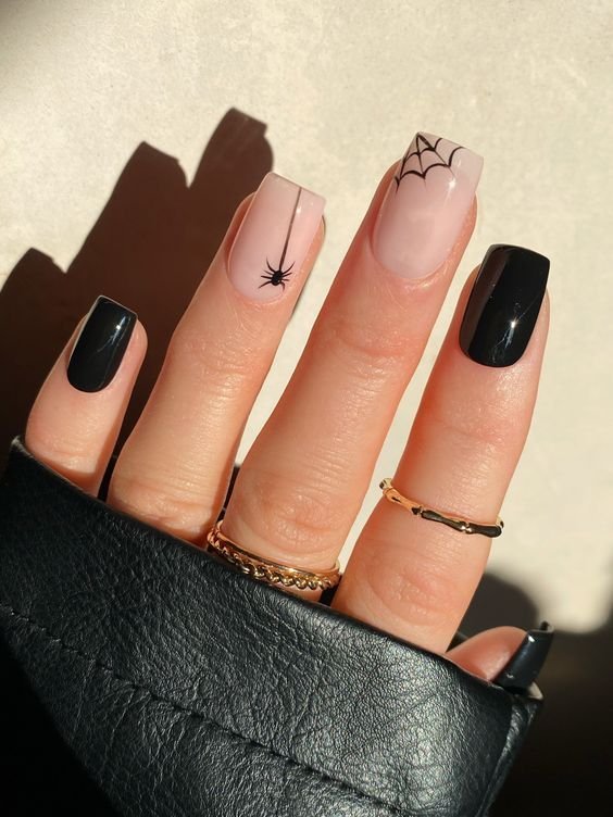 Minimalist sheer nude nails with delicate black spiderweb accent