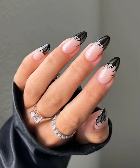 Sheer nude nails with tiny black bat silhouettes
