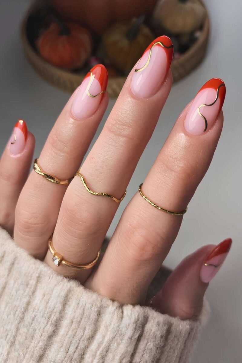 Sheer nails with thin burnt orange French sliver tips
