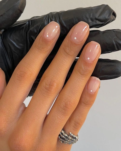 Clear nude nails with single tiny pumpkin orange dot accent