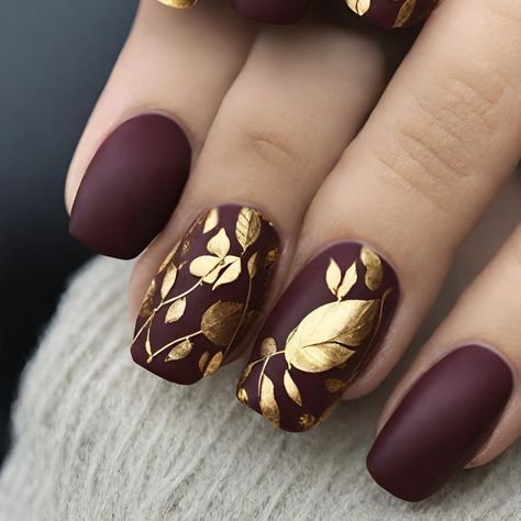 Burgundy nails with gold foil flakes