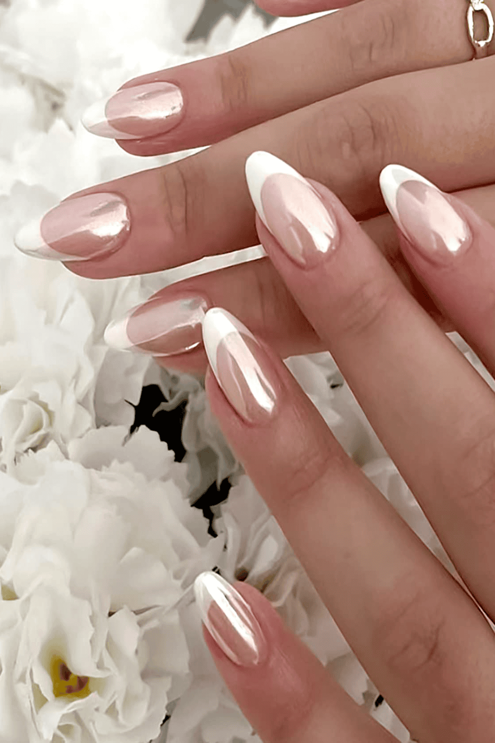 Nude nails with holographic chrome French tips