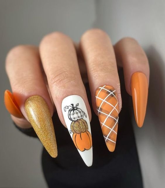 Burnt orange nails with gold foil accents