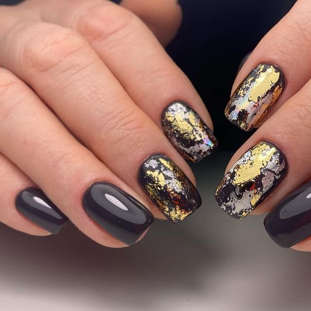 Mustard yellow nails with gold foil flakes
