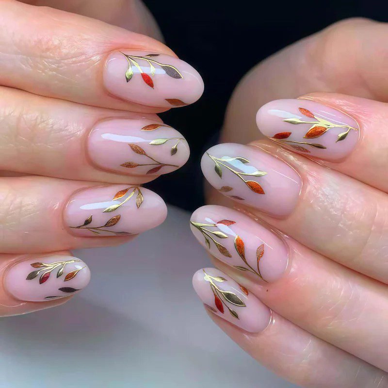 Sheer pink nails with gold foil confetti