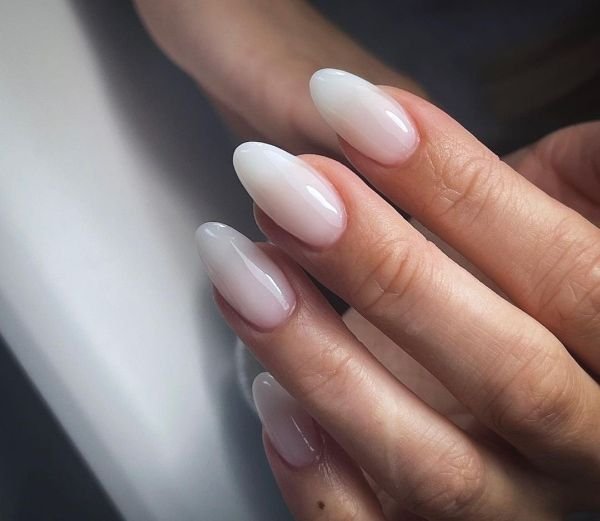 White ombre tip nails fading from nude to milky white