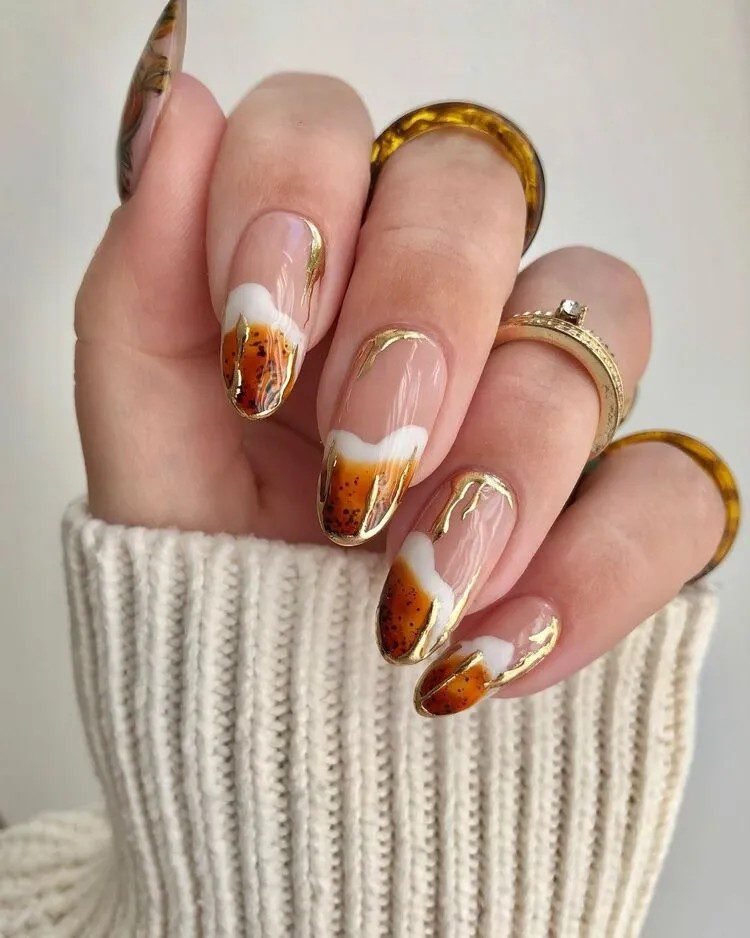 Mini pumpkin nail art on burnt orange
