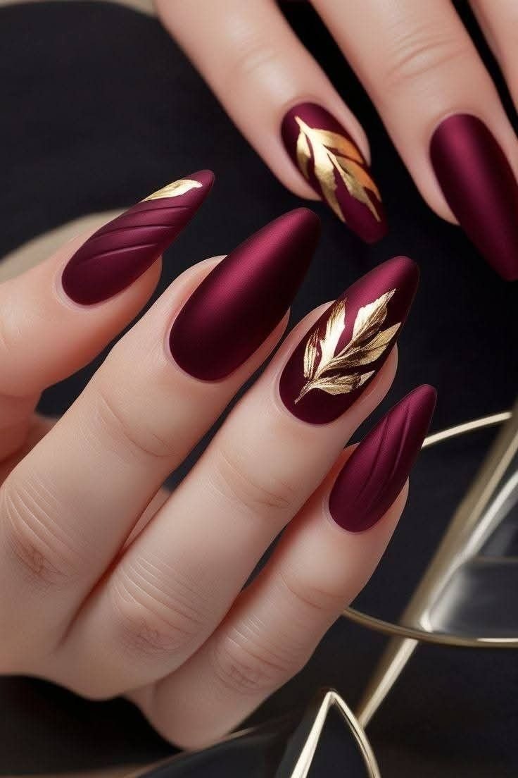 Burnt orange nails with gold leaf accents