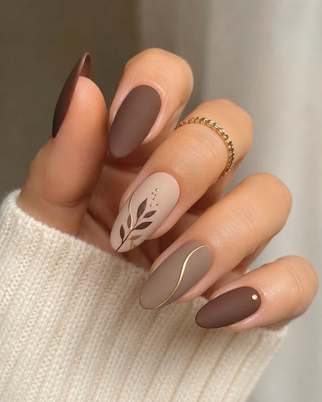 Nude almond nails with autumn leaf art