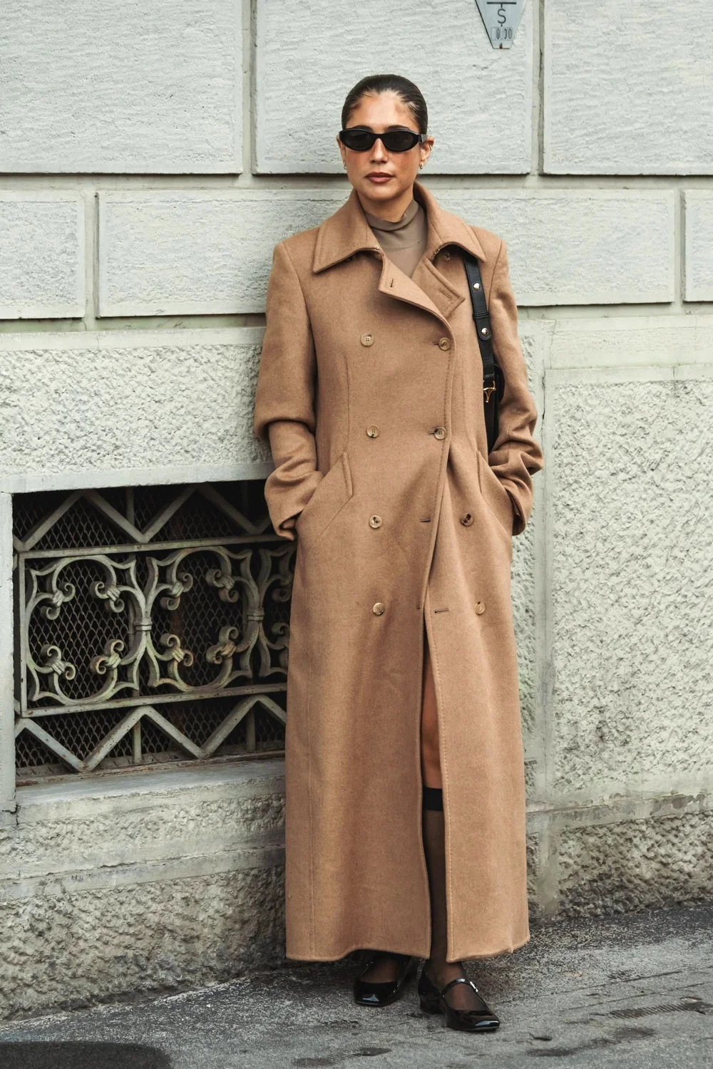 Plus size camel wool wrap coat over black jeans