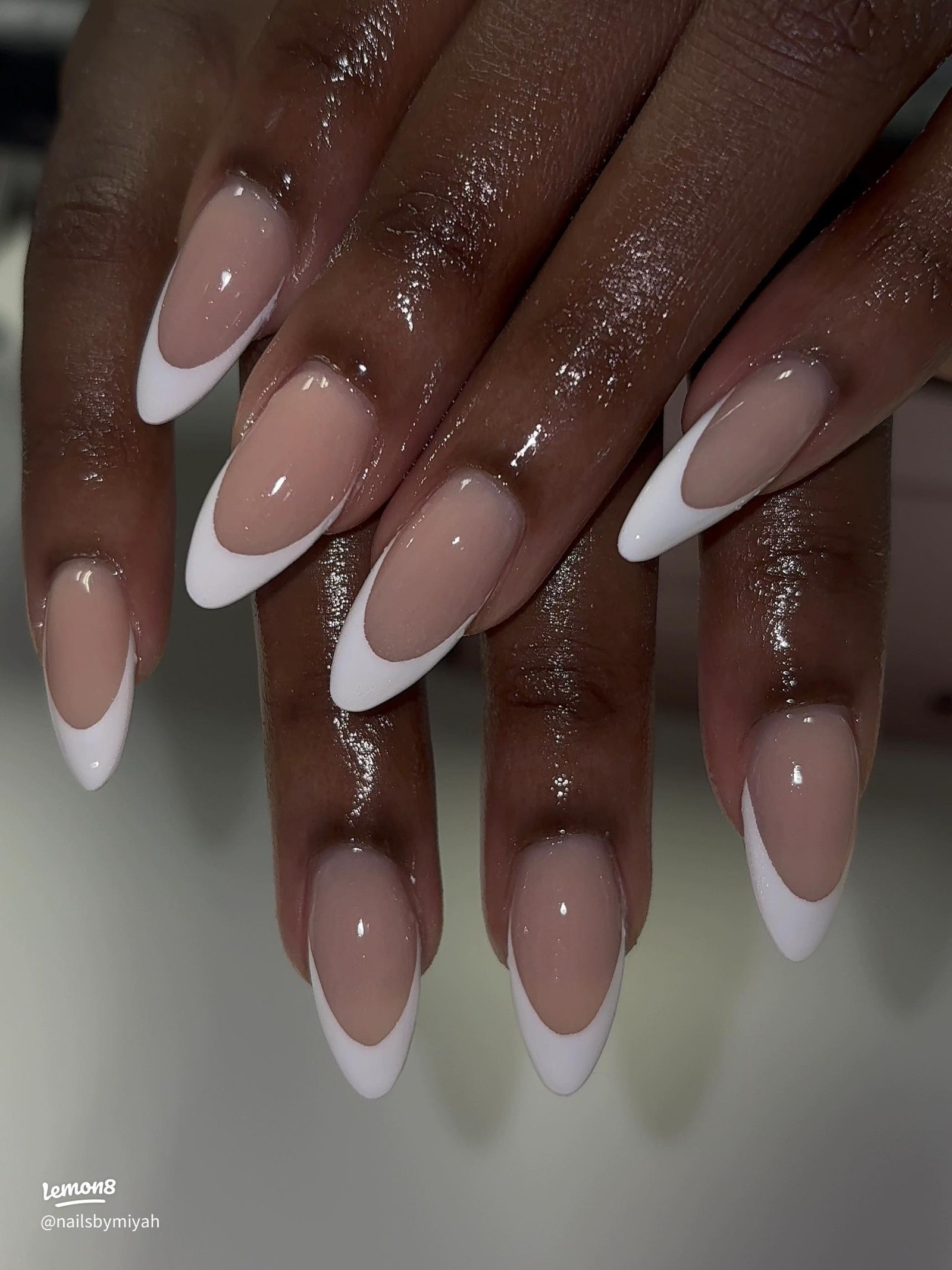 Classic white French tip manicure on almond nails