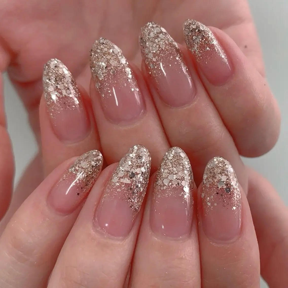 Nude nails with champagne glitter fade from tips