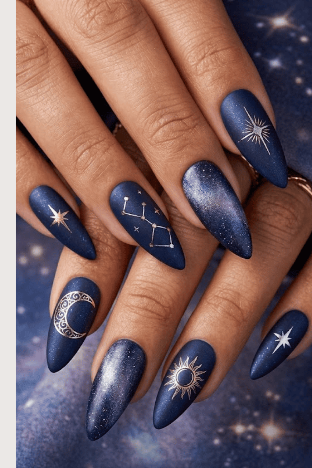 Midnight blue nails with gold zodiac symbol nail art