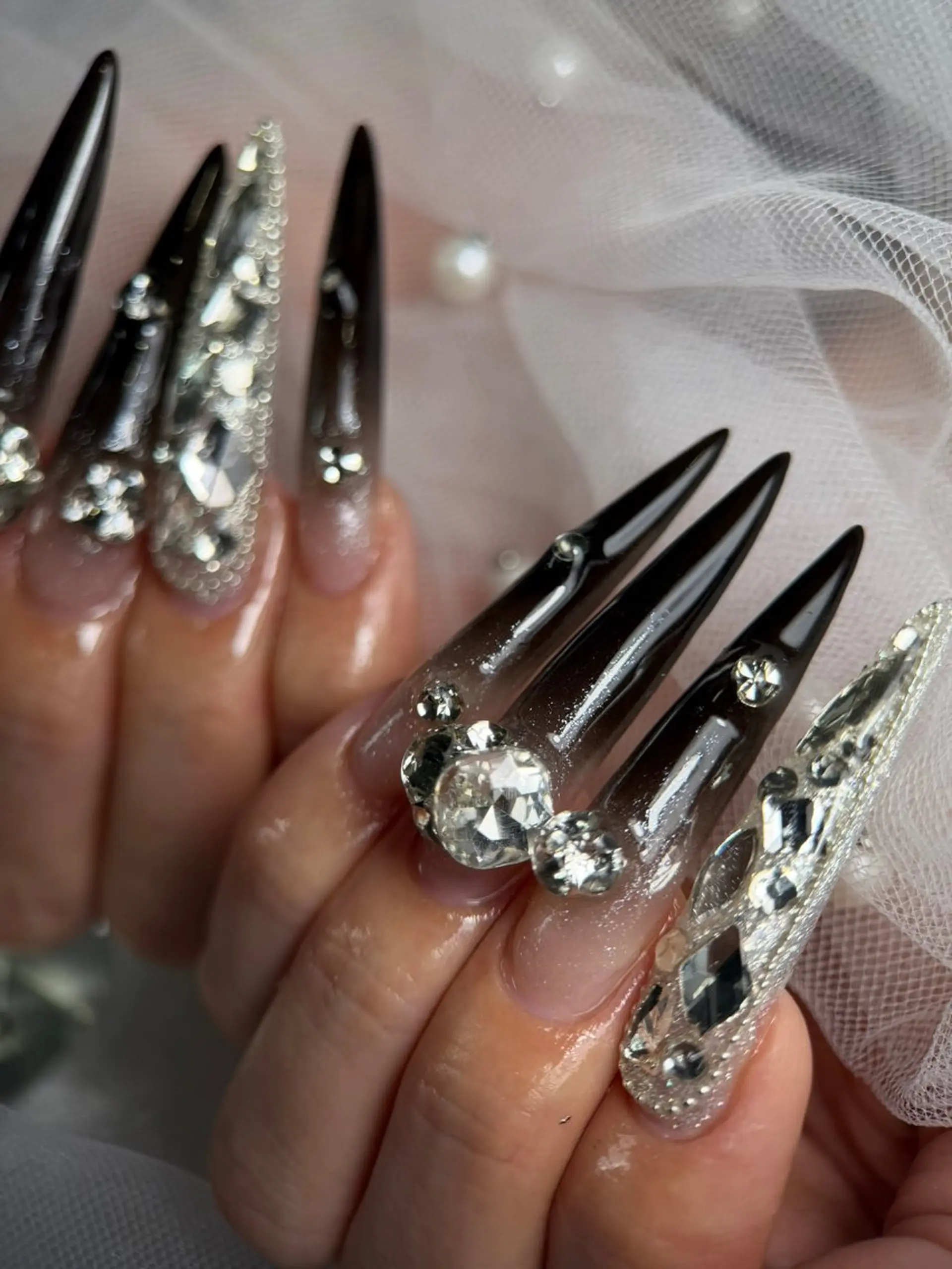 Black velvet textured nails with scattered crystal stars