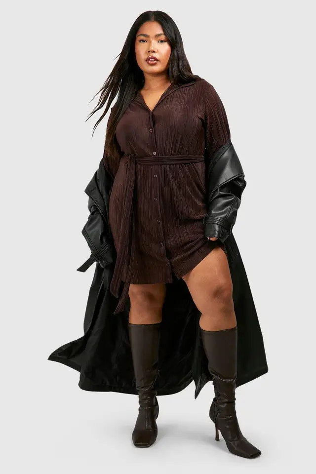 Plus size woman in a belted utility shirt dress