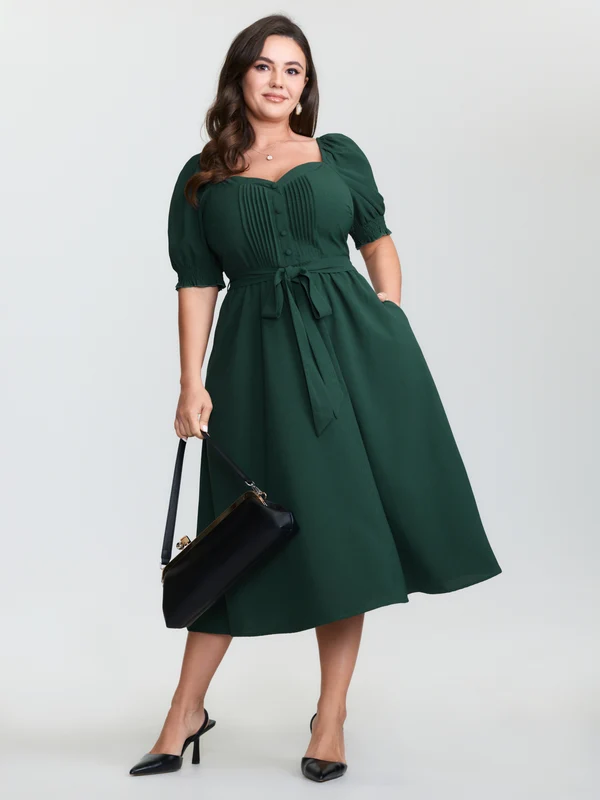 Plus size woman wearing a puff-sleeve midi dress