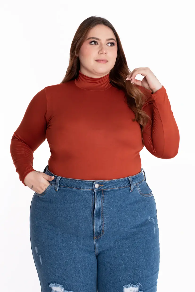 Plus size woman wearing high-rise flare jeans with a turtleneck bodysuit