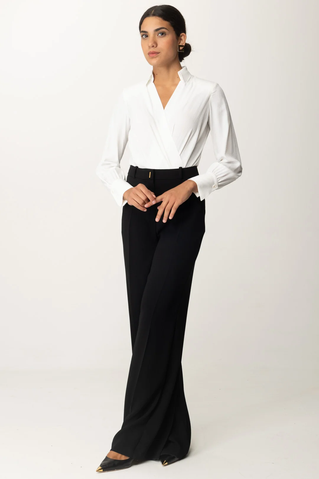 Woman wearing a wrap blouse with high-waisted trousers for work