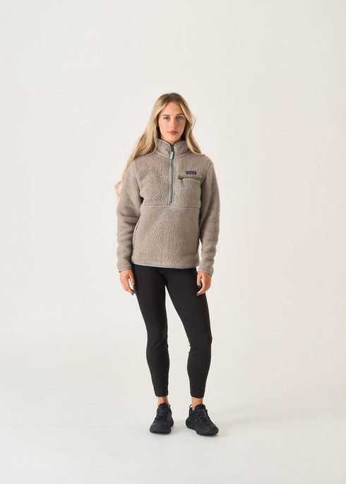 Woman wearing a quarter-zip fleece with leggings