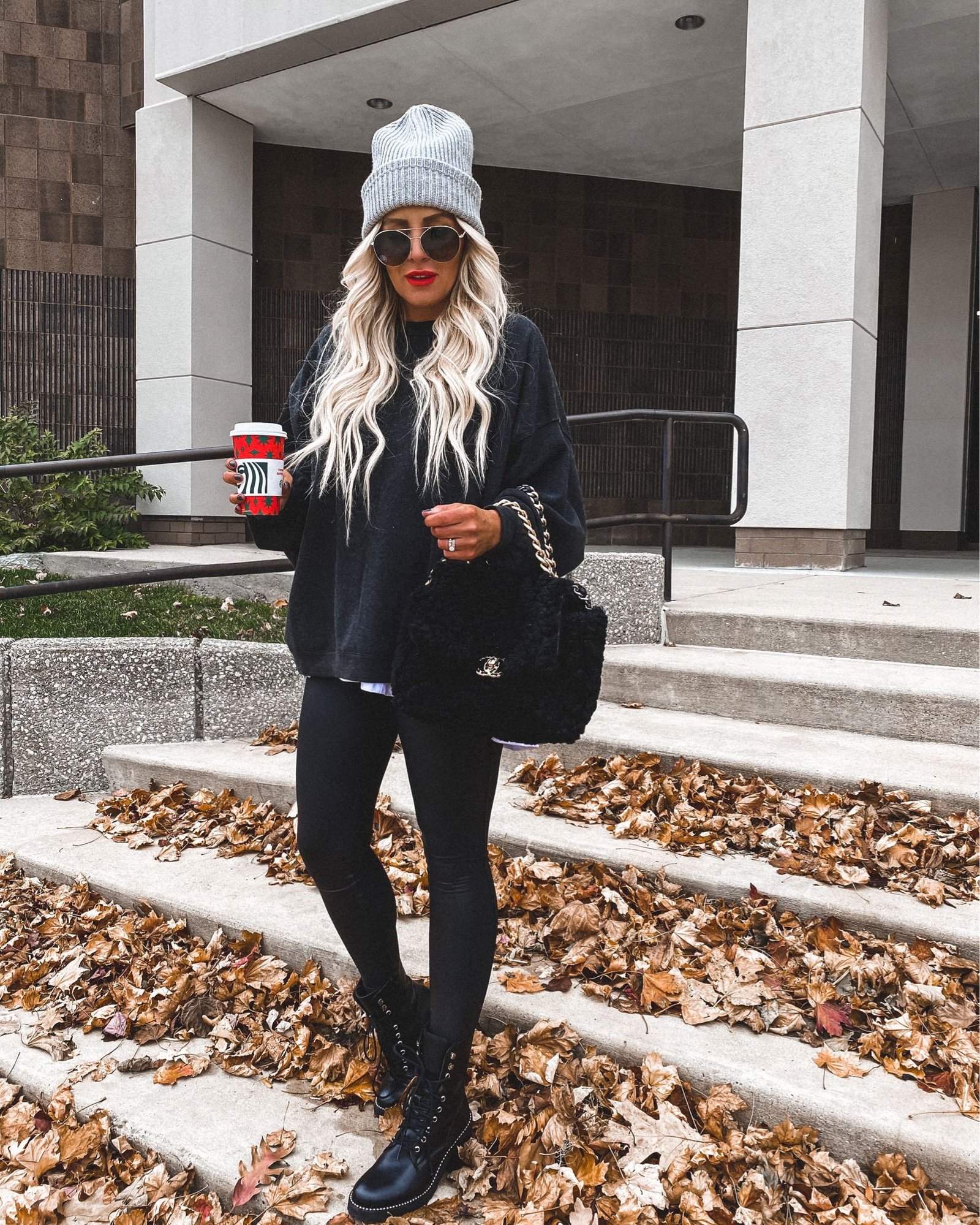 Woman wearing fleece-lined leggings with an oversized sweater and beanie