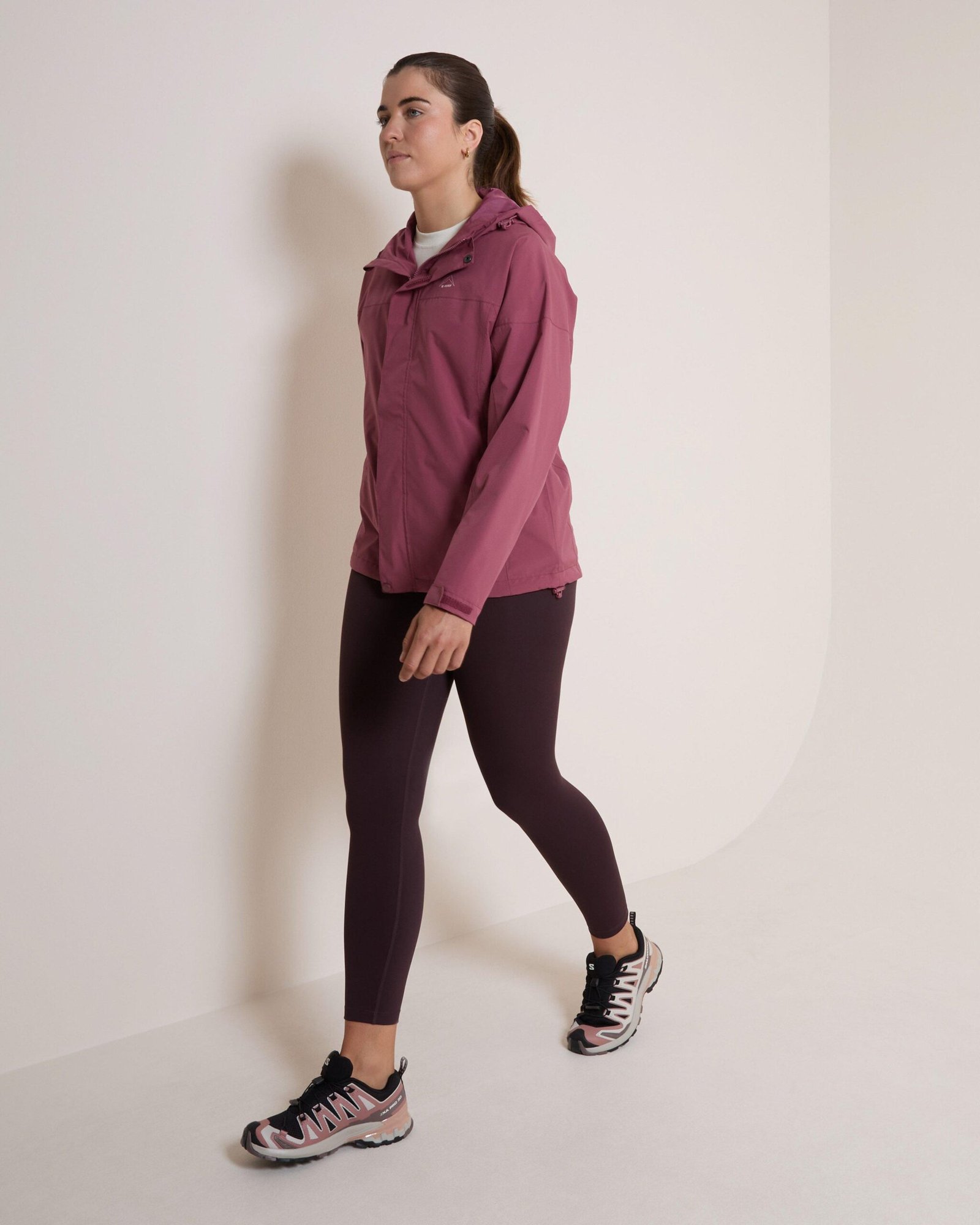 Woman in an all-weather athleisure outfit with a rain shell