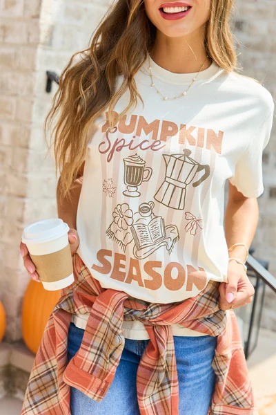 Woman with flannel tied around waist over graphic tee and jeans