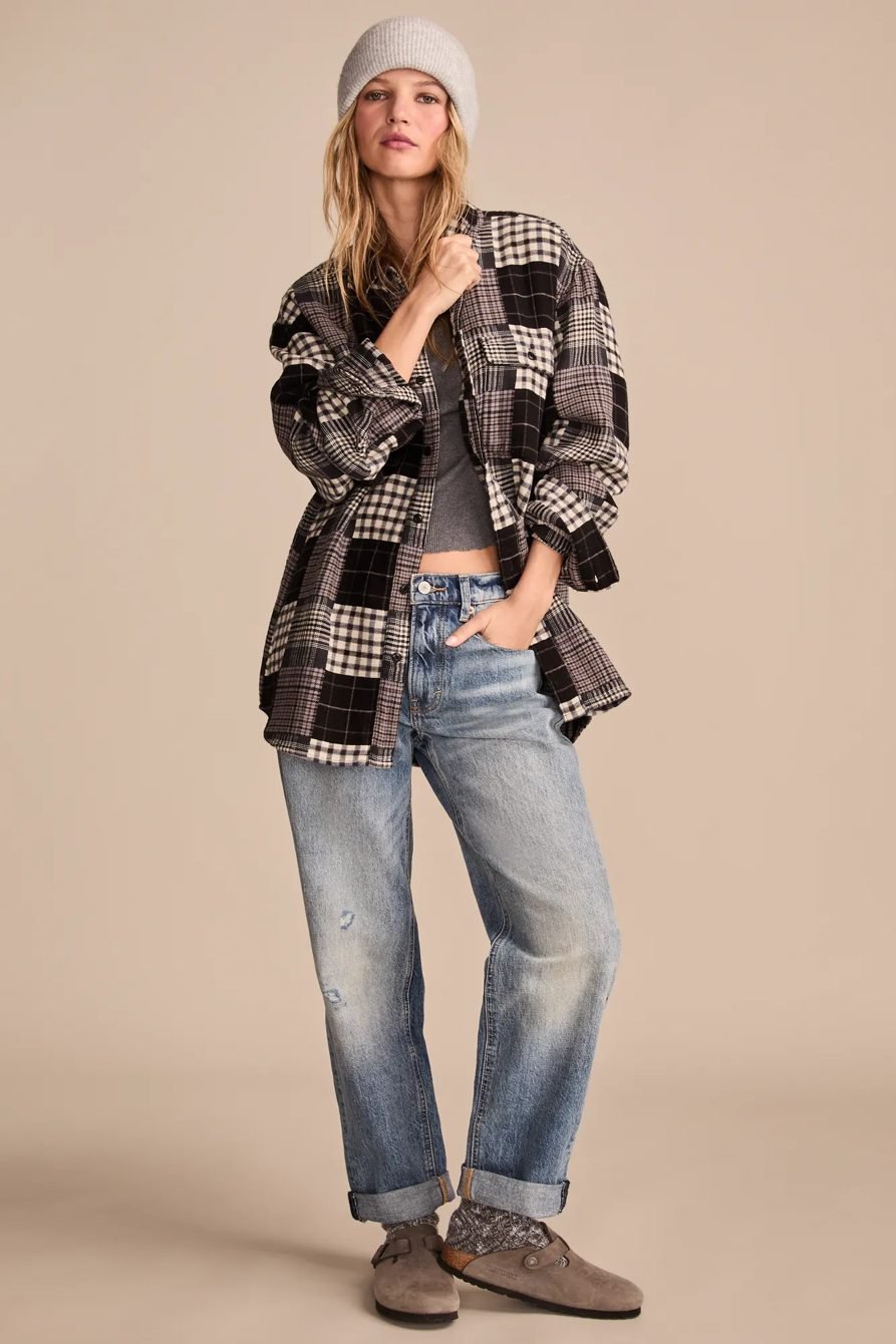 Woman wearing flannel with a beanie and boyfriend jeans