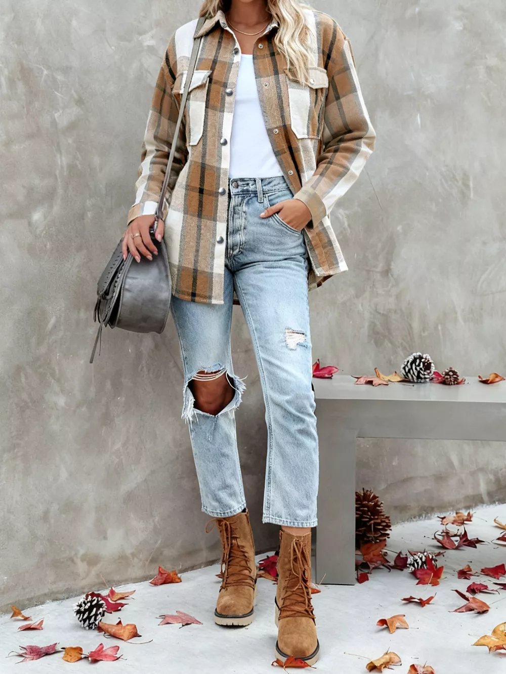 Woman wearing a plaid flannel shacket with jeans and boots
