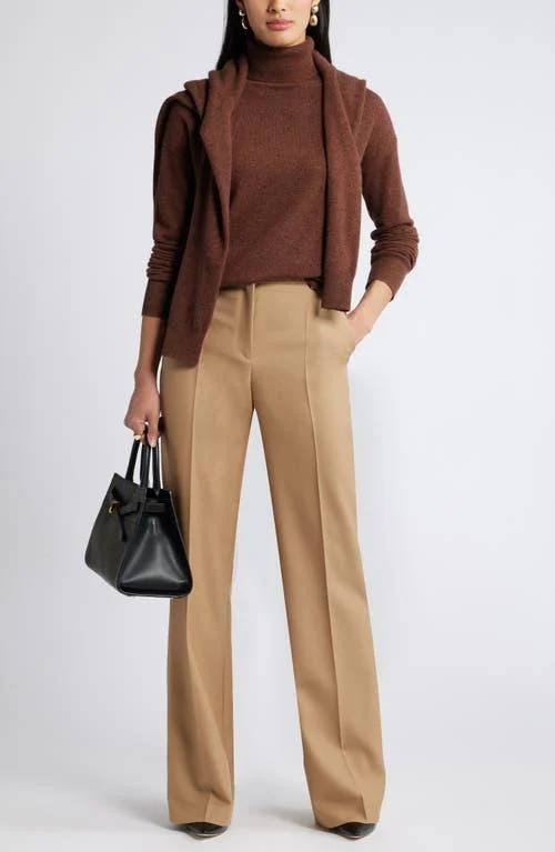 Woman wearing a cashmere sweater with tailored trousers