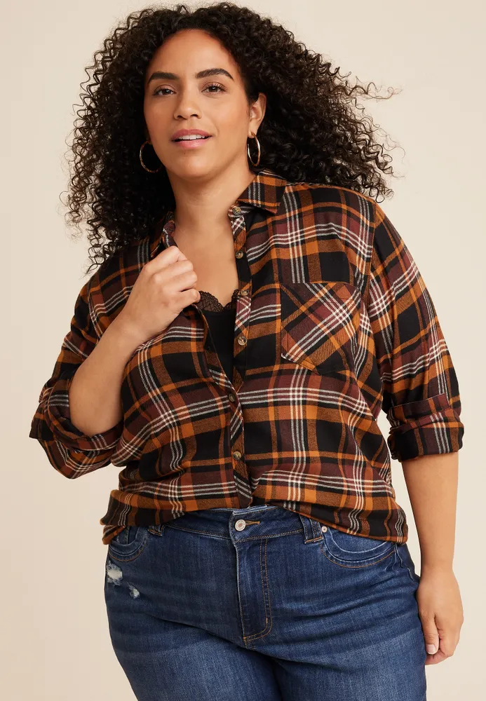 Plus size woman in plaid shirt dark jeans and boots pumpkin patch