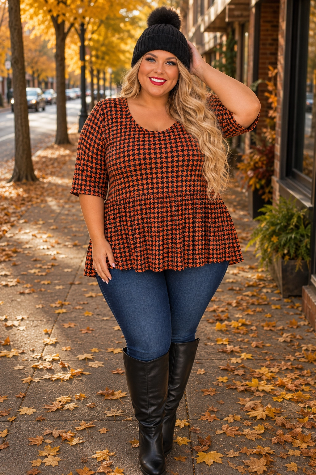 Plus size woman in peplum top with skinny jeans and boots