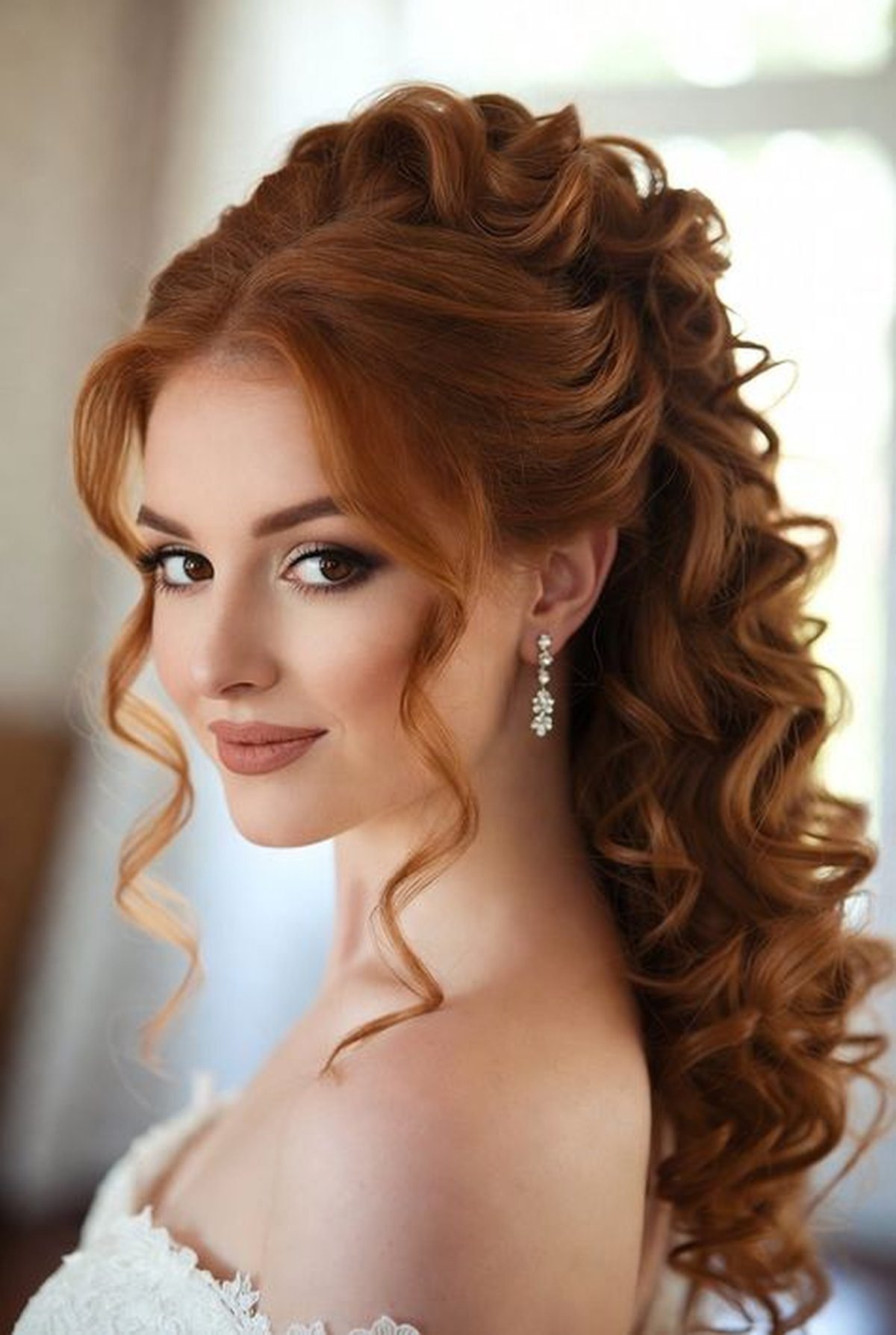 Curled half-up hairstyle with volume on a woman, romantic date night hair