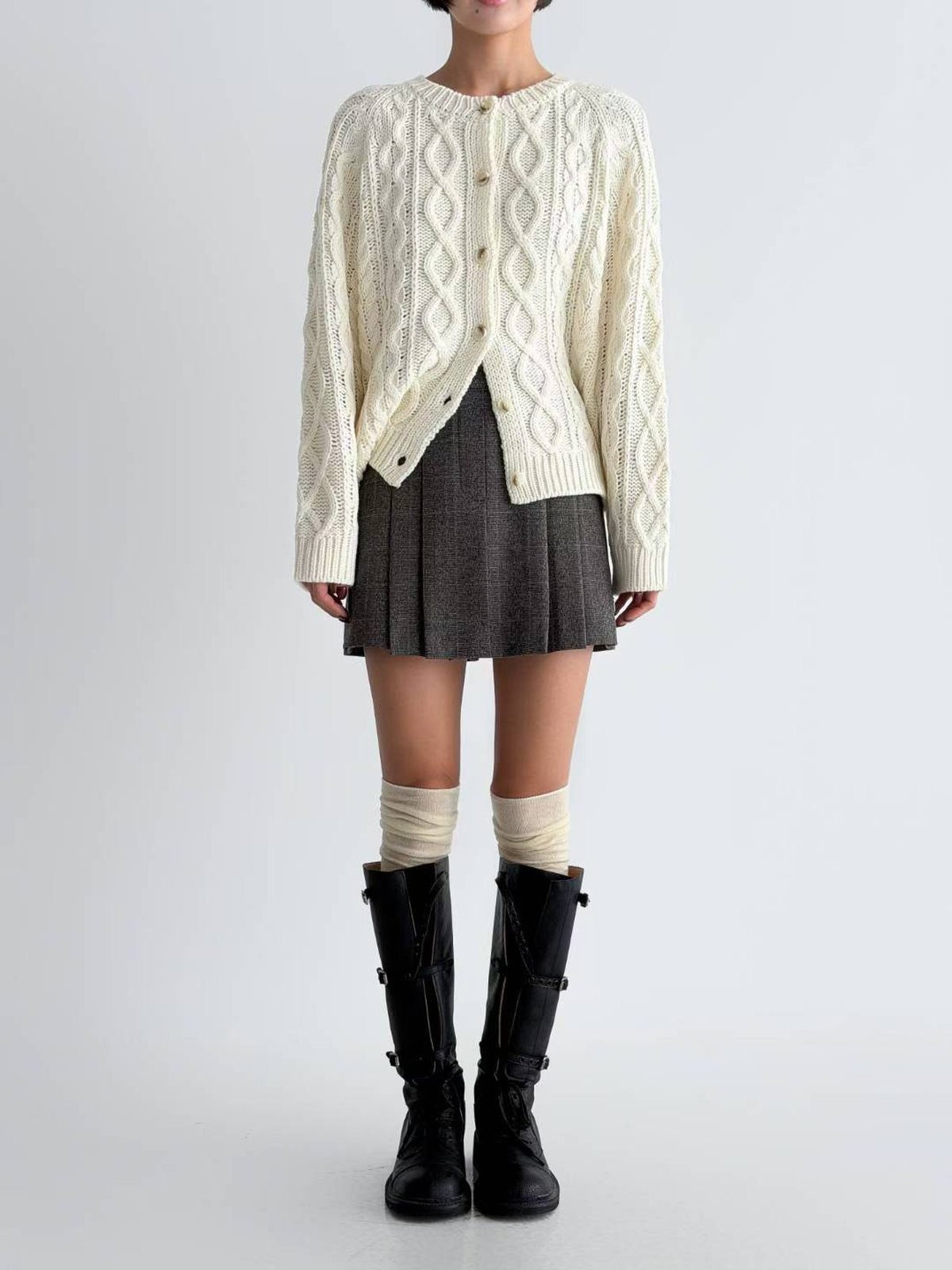 Woman wearing a tennis skirt with a cardigan and knee socks in fall