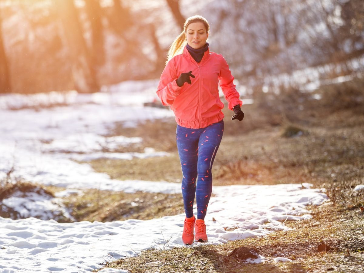 Woman running in a softshell winter jacket for cold weather