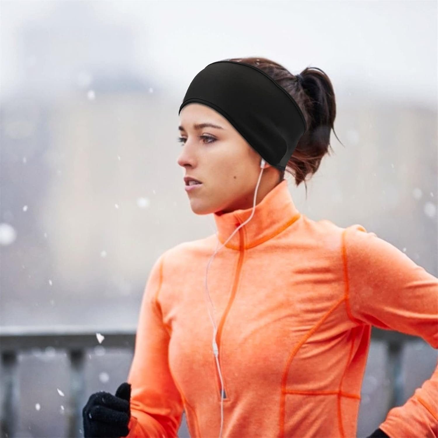 Woman running with an ear warmer headband and gloves in the cold