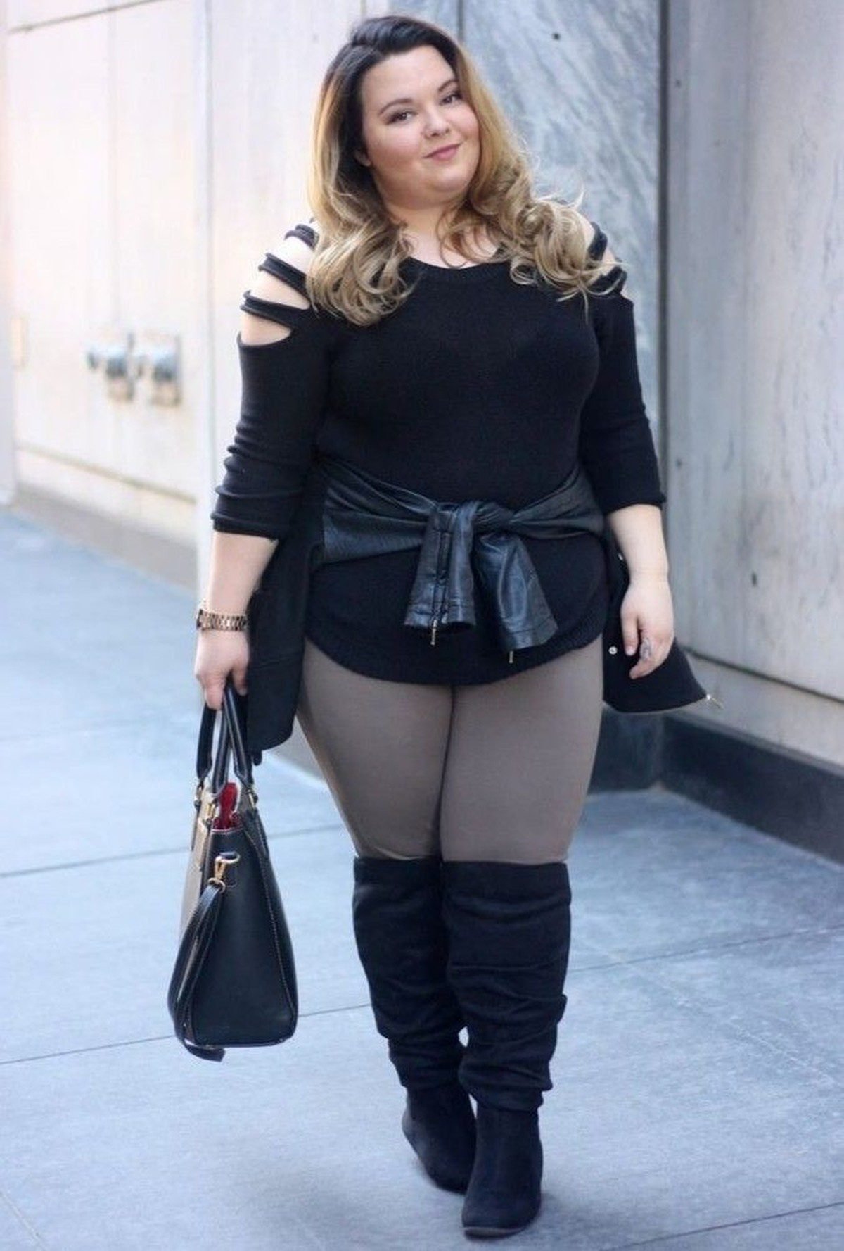 Plus size puffer vest layered over hoodie with leggings for fall warmth