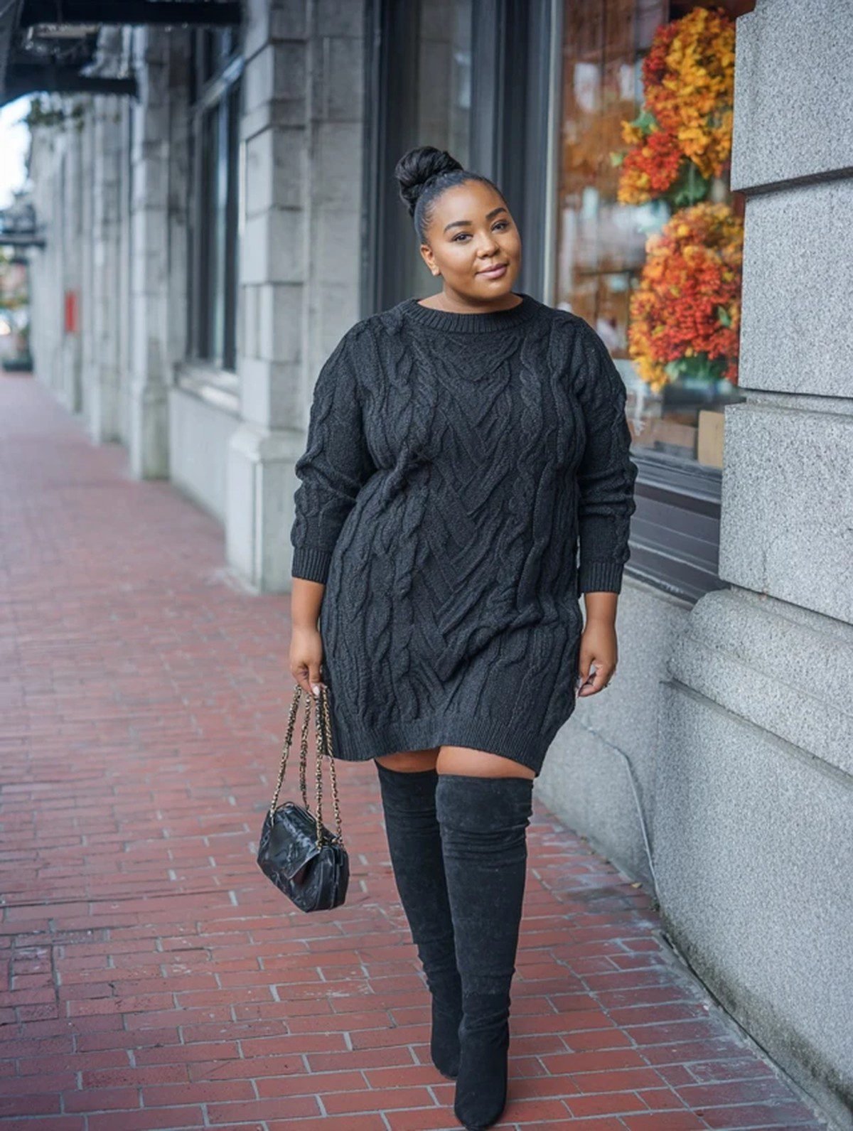 Plus size woman wearing knee-high wide-calf boots with a sweater dress for fall